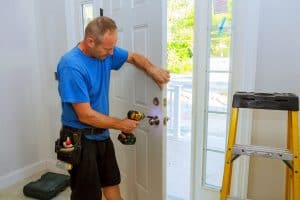 contractor replacing a front door lock