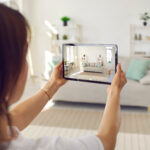 Woman taking a photo of her living room for her home inventory