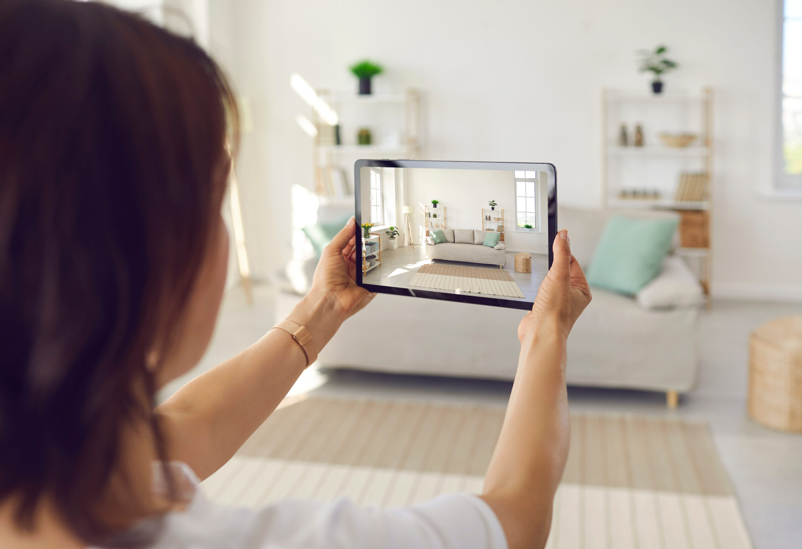 Woman taking a photo of her living room for her home inventory