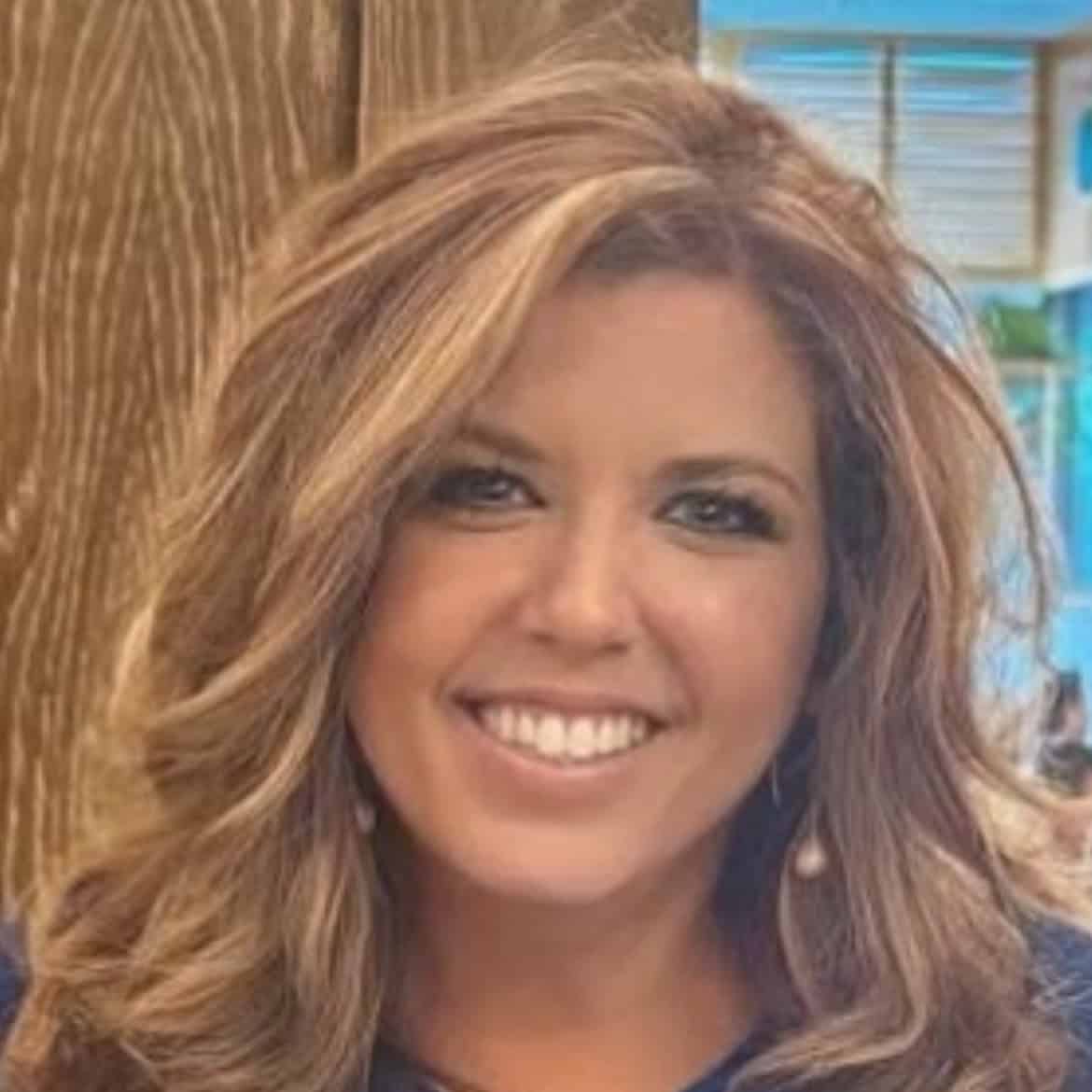 Dionne Tucker; Blond woman smiling for a headshot photo