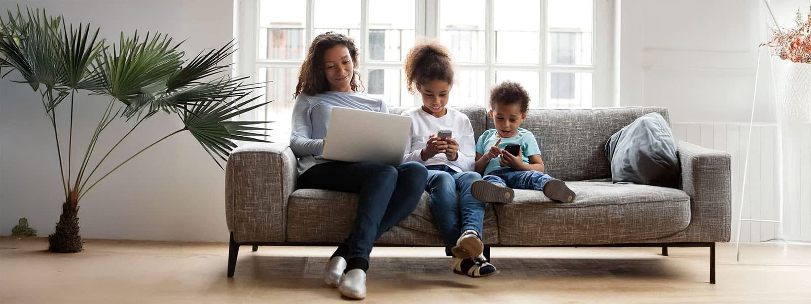 Mother and kids on electronic devices