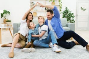 Family enjoying playful moment on living room floor, symbolizing home safety and protection with Tower Hill Insurance.