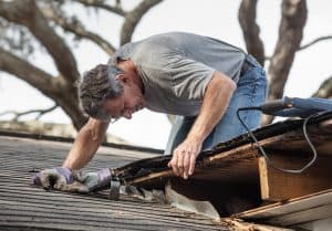 Man on damaged roof
