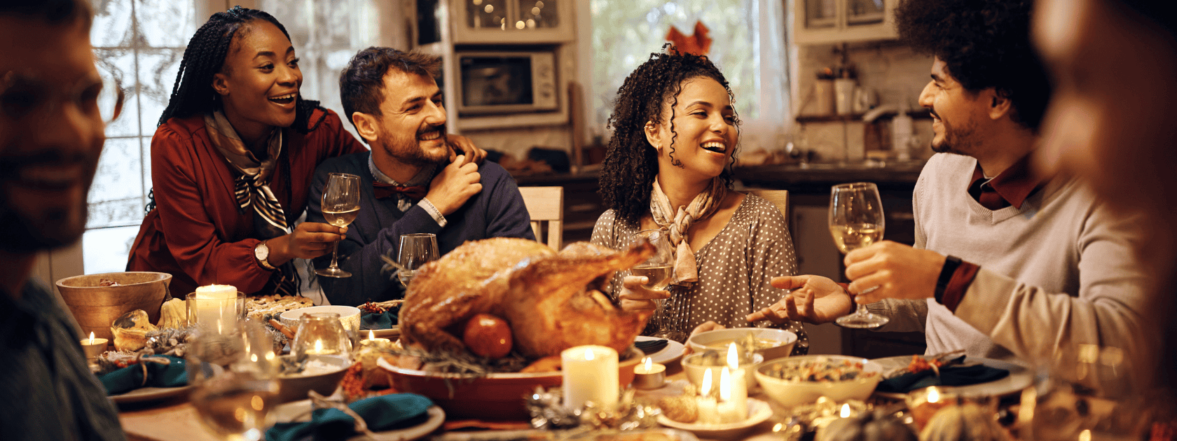 Group of friends around thanksgiving dinner table