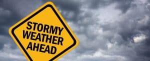 Street sign reading "Stormy Weather Ahead"